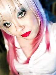 A blonde, curvaceous woman is undressing.