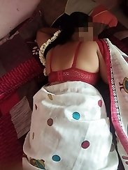 A curvaceous woman kneels down and performs oral sex on a well-endowed man.