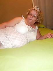 Hairy chubby bitch is posing seminaked at home
